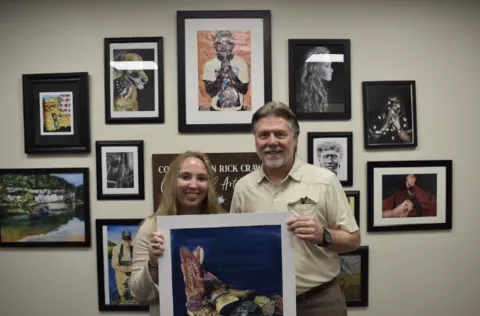Sophie Vanlandingham (left) and Congressman Rick Crawford (right) pictured in front of Ms. Vanlandingham’s winning painting “Cowboy Collection.” 